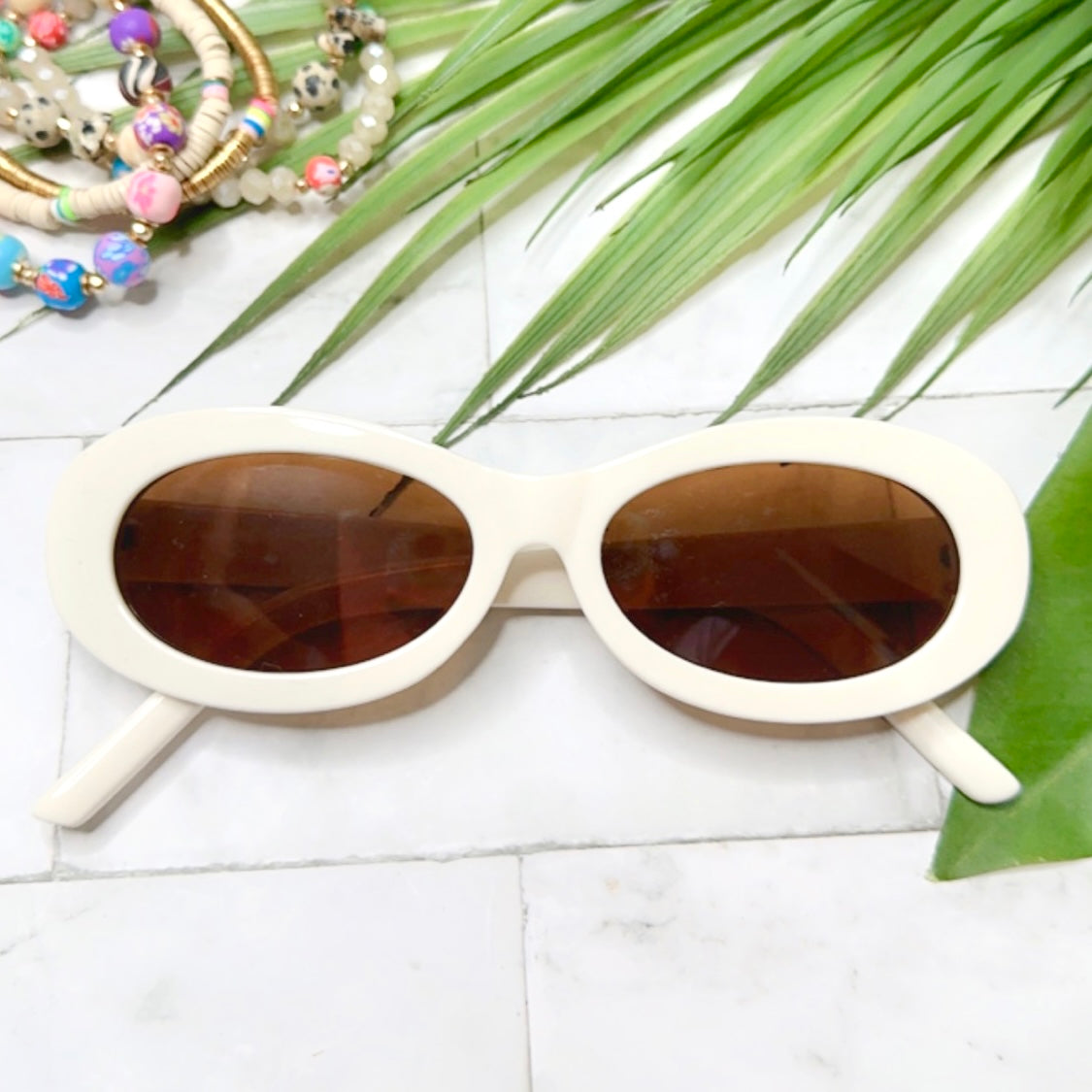 white oval shaped sunglasses